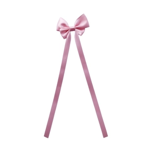Close-up of pink satin bow hair clip with long ribbons featuring a silky texture