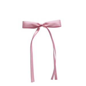 Detailed close-up of a pink satin bow hairclip with elegant long ribbon streamers