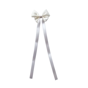 Detailed view of cream satin bow hair clip with long elegant ribbon streamers