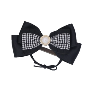 Elegant houndstooth bow hair clip with large faux pearl accent and black ribbon detailing