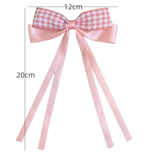 Pink houndstooth bow hair clip with long satin ribbons measuring 12cm by 20cm