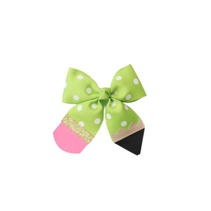 Detail of pencil themed bow hair clip with green polka dot ribbon and glitter textures