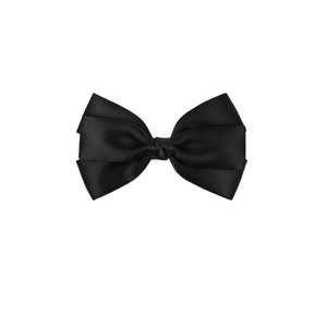 Detail of layered black satin ribbon hair bow with smooth silky texture on white background