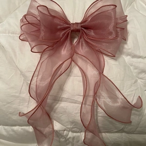 Detail of dusty pink double-layered organza ribbon bow with delicate stitched edges