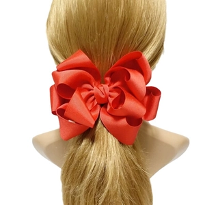 Large multi-layered red grosgrain ribbon bow hair clip for girls worn on blonde hair
