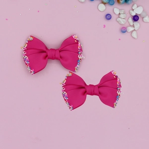 Close-up of rose red grosgrain ribbon hair bows with colorful sprinkles for children