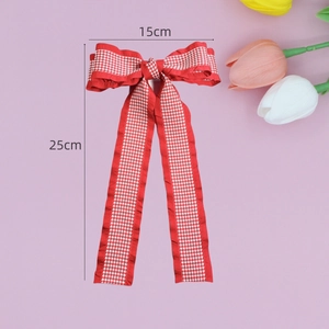 Houndstooth bow hair clip with ribbons 15x25cm dimensions displayed on pink background