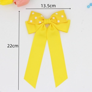 Fermaglio per capelli con fiocco giallo a pois e lunghi nastri per donne chic