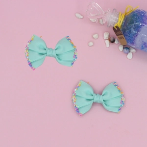 Detail of mint green grosgrain ribbon hair bows with colorful sprinkle decorations
