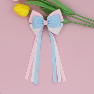 Detail of multi-color grosgrain ribbon bow with long flowing streamers and tulips