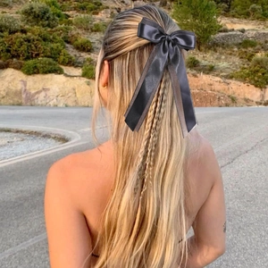 Classic double-layered black satin bow hair clip with long ribbons for elegant styling