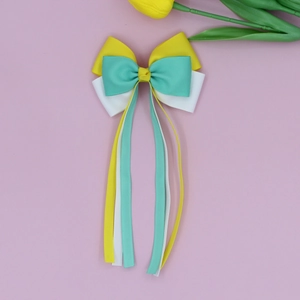 Detailed close-up of tricolor ribbed ribbon bow hairclip with long streamers for girls