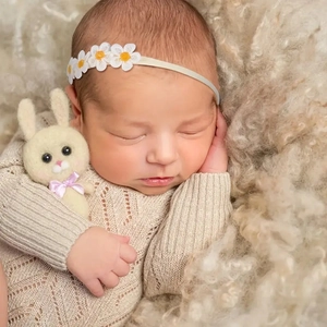 Sweet newborn baby daisy headband with five small white flowers on soft beige elastic band