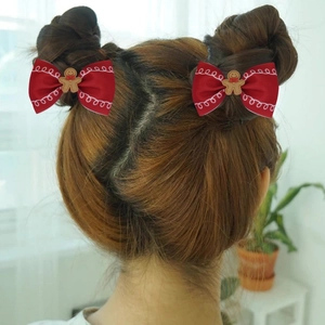 Pair of red gingerbread man hair bows on ribbon clips for girls holiday hairstyle