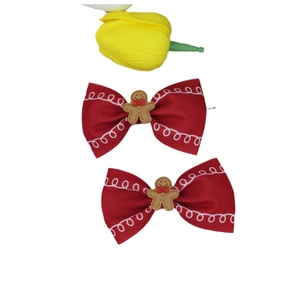 Set of two red ribbon hair clips with gingerbread man decor for Christmas holiday