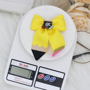 Pencil-themed yellow grosgrain ribbon bow hair clip with ABC apple charm for girls