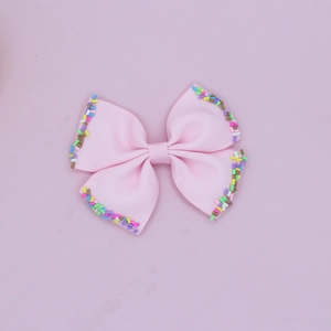 Pink grosgrain ribbon bow hair clips with colorful sprinkle decorations for kids