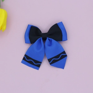 Close-up of grosgrain ribbon bow hair clip with blue and black wavy pattern design