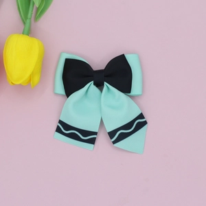 Close-up detail of mint green and black layered grosgrain bow hair clip for school girls