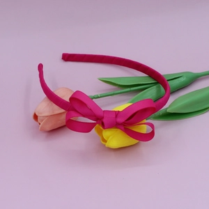 Detailed view of the layered dark pink grosgrain bow and textured headband cover