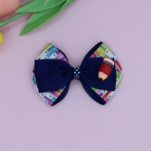 Detailed view of back to school hair bow with pencil patterns and resin pencil charm