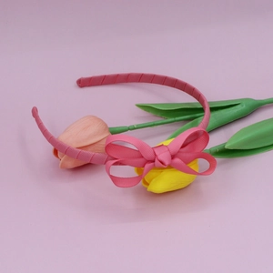 Close-up of pink ribbed fabric headband with a double-layered sweet bow design