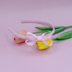 Detail of pink ribbed ribbon headband with double-layered bow and elegant texture
