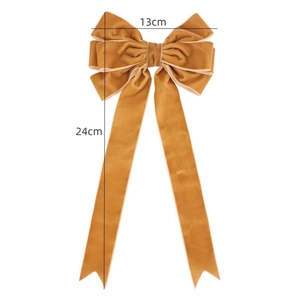 Close-up of golden velvet Christmas bow showing 13cm width and 24cm length details