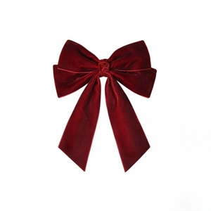 Dettaglio di fiocco in velluto rosso scuro con nastri lunghi ed eleganti per capelli