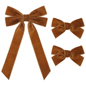 Detail of three caramel velvet hair bows showing soft fabric texture and elegant stitching