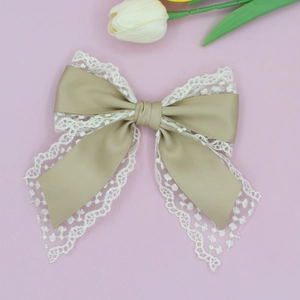 Elegant champagne satin and lace bow hair clip for women with a French vintage style