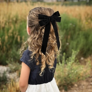 3-pack black velvet bow hair clips with long ribbons on a child's blonde hair