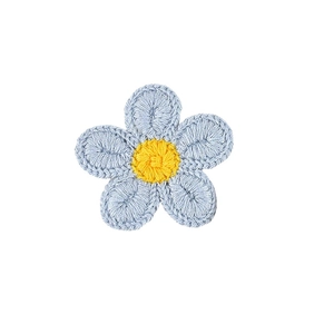 Close-up of handmade crochet flower hair clip in light blue and yellow yarn detail