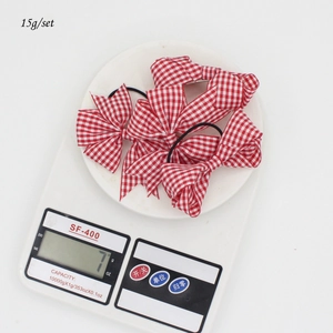 Set di 8 elastici per capelli con fiocco a quadretti bianchi e rossi da 15 grammi
