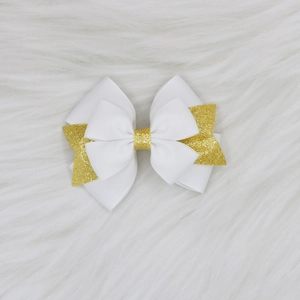 Détail de la pince à cheveux multicouche en ruban gros-grain blanc avec centre doré