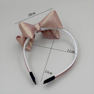 Cerchietto elegante con fiocco color oro champagne con finitura glitterata e pettine