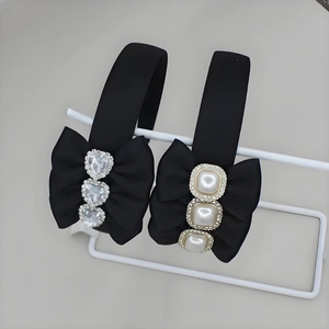 Elegant black satin headbands with bows featuring crystal hearts and pearl details