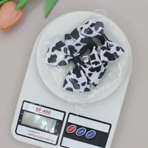 Set of 2 cow print bow hair clips made of grosgrain ribbon with metal alligator base
