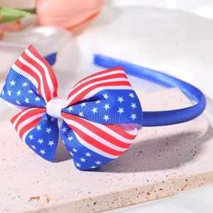Independence Day headband with stars and stripes bow on a textured stone display