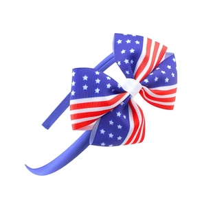 Detailed view of patriotic bow headband featuring red stripes and white stars on blue fabric