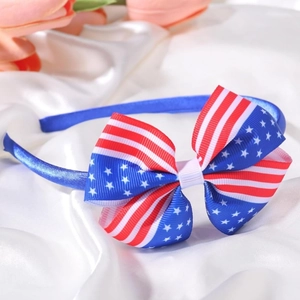 Close-up of USA flag pattern bow headband with red stripes and white stars on blue fabric