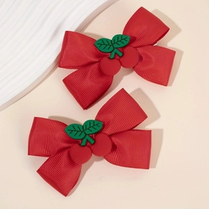 Detailed view of red grosgrain ribbon hair bows with cute plastic cherry ornaments