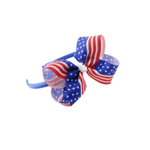 Detailed close-up of a large Independence Day hair bow with American flag star and stripe patterns