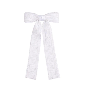 Detailed view of delicate white lace bow hair clip with long ribbons in French sweet style