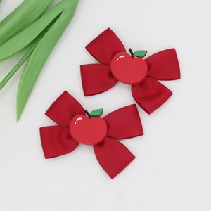 Pair of red grosgrain ribbon bow hair clips with cute cartoon apple resin center pieces