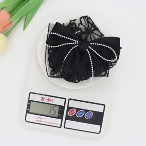 Elegant black lace bow hair clip with white pearl chain detail weighing only 15g