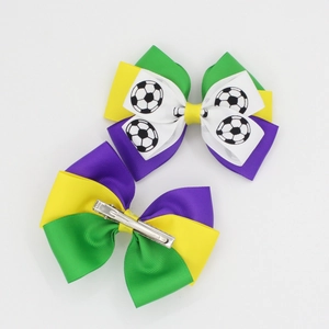 Brazilian Carnival hair clips with colorful ribbons and football pattern on white background