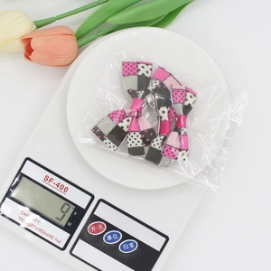Pink and black grosgrain ribbon bow hair clips with polka dots and plaid patterns