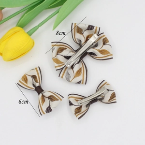 Three-piece ethnic jacquard bow hair clip set with brown and yellow leaf prints