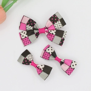 Close-up of three-piece grosgrain ribbon bow set with polka dots and plaid patterns